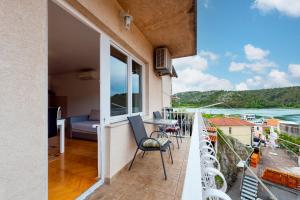 a balcony with a view of the ocean at Apartments Duilo in Skradin