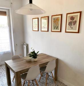 a dining room with a wooden table and chairs at Foscolo 20 in La Spezia