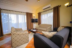 uma sala de estar com dois sofás e uma televisão em Colosseum Boutique Hotel & Spa em Dar es Salaam