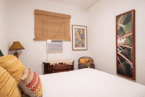 a bedroom with a white bed and a window at Beach Pad w Patio, walk to everything! GEN AC - 20 Down in San Juan