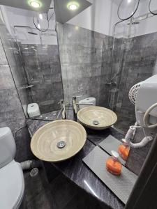 a bathroom with a sink and a shower and a toilet at Old Town Constanta in Constanţa