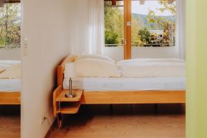 a bedroom with two beds and a window at Lindenhaus in Zwiesel