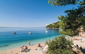 a group of people on a beach in the water at Blu Breeze Apartments in Lokva Rogoznica