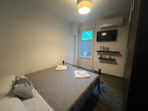 a bedroom with a bed with two towels on it at Elegant Loft 2 in Alexandroupoli