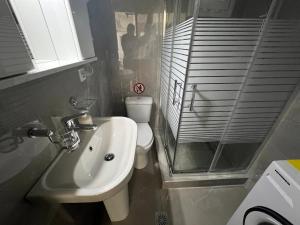 a small bathroom with a sink and a toilet at Elegant Loft 2 in Alexandroupoli +27 photos