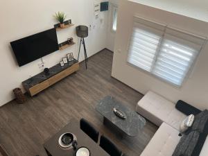 an overhead view of a living room with a flat screen tv at Elegant Loft 2 in Alexandroupoli