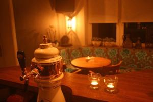 a living room with a table and candles on a table at Tolles Ferienhaus für 18 Personen in Ostfriesland mit Kino, Bar, Sauna und Whirlpool in Backemoor