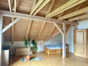 Zimmer im Dachgeschoss mit einem Bett und einer Holzdecke in der Unterkunft Apartmán Lazec in Český Krumlov