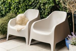 two white chairs sitting next to each other at Sfeervol Tiny House met luxe jacuzzi & tuinkamer in Heerenveen