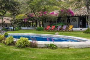 a swimming pool in the yard of a house at Hacienda San Francisco in Tumbabiro