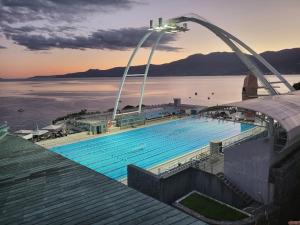 a large swimming pool on top of a building at My Way room, parking, sea view, terrace in Rijeka