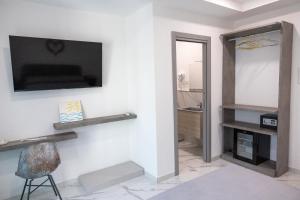 a living room with a television and a chair at affittacamere amare in Marina di Camerota