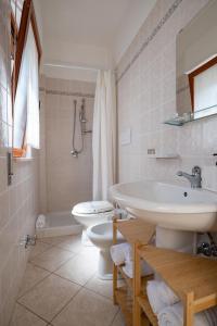 a bathroom with a sink and a toilet at Residence Lido dei Pini in Mattinata +27 photos