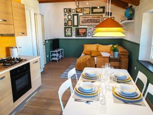 a kitchen and living room with a table and chairs at Jungle in Lucca in Capannori