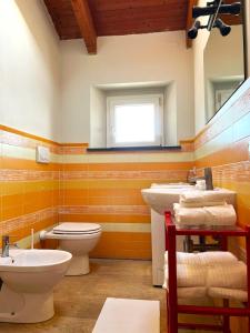 a bathroom with a toilet and a sink and a mirror at Jungle in Lucca in Capannori