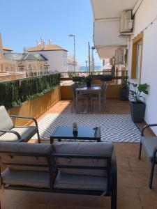 a patio with a table and chairs on a balcony at APARTAMENTO DE LUJO EN LA VERA PLAYa GARRUCHA in Vera