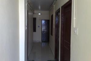 an empty hallway with a door in a room at GRG Shanti Guest House Varanasi Near Manikarnika Ghat in Varanasi