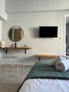 a bedroom with a bed and a tv on the wall at Flats 5-11 apts in Heraklio