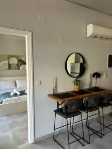 a room with a table and a mirror and a bed at Flats 5-11 apts in Heraklio