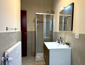 a bathroom with a sink and a shower at Appartamento del Palio in Asti +21 photos