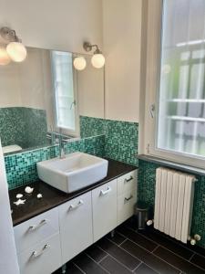 a bathroom with a sink and a mirror at Casa Marchese in Tirrenia