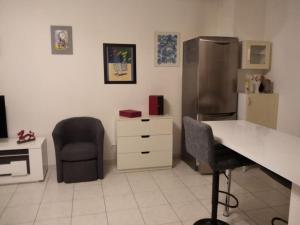 a kitchen with a desk and a chair and a refrigerator at Grand 2p proche Paris in Viry-Châtillon