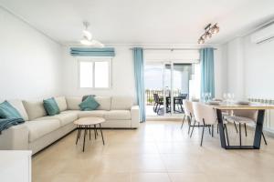 a living room with a white couch and a table at Stunning apartment at La Torre Golf Resort MO6022L in Roldán
