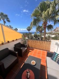 a patio with furniture and a view of the ocean at Bluejay Apartamento Playa del Cura in Playa del Cura