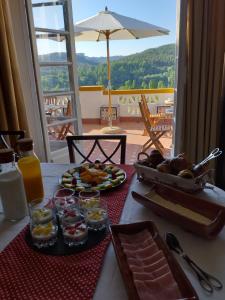 a table with plates of food on a table with a view at Casa da Praia do Ribatejo - Casa da Arcada in Praia do Ribatejo