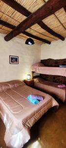 a bedroom with three bunk beds in a room at Postales del Tiempo in Tilcara