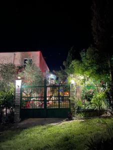 a gate in a yard at night with lights at HILL Of SAN PIETRO in Durrës +22 photos