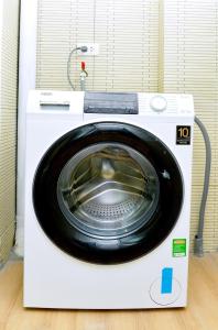 a dryer with a washing machine in a room at Era Apartment Trung Liet in Hanoi