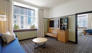 a hotel room with a bed and a tv at L7 Chicago by LOTTE in Chicago