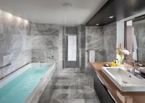 a bathroom with a tub and a sink at Mandarin Oriental, Geneva in Geneva