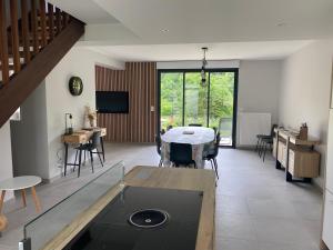 ein großes Wohnzimmer mit einem Tisch und Stühlen in der Unterkunft La chapelle in Fervaches