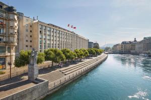 a river with buildings and trees next to a river at Mandarin Oriental, Geneva in Geneva