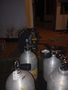 a group of metal tanks sitting next to each other at Arborek Diving Homestay R4 in Besir