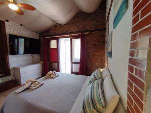 a bedroom with a bed and a brick wall at House Viareggio in Viareggio