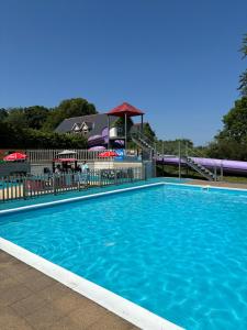 a large blue swimming pool with a gazebo at Serene Sea Valley in Bucks Mills +6 photos