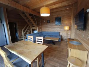 a living room with a table and a blue couch at Katilux willa in Nowy Targ
