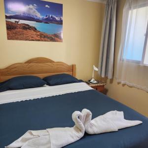 a bedroom with a bed with towels on it at Bellissa House in Antofagasta