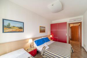 una camera con letto e armadietto rosso di Residenza Al Parco a Bibione