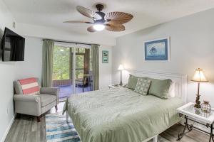 a bedroom with a bed and a ceiling fan at Hot Springs Retreat with Private Dock and Hot Tub! in Hot Springs +28 photos