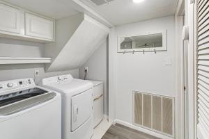 a white laundry room with a washer and dryer at Hot Springs Retreat with Private Dock and Hot Tub! in Hot Springs