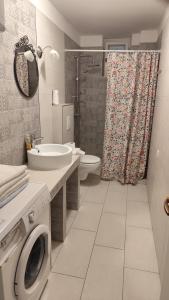 a bathroom with a washing machine and a sink at Apartment Seventh Continent in Šibenik
