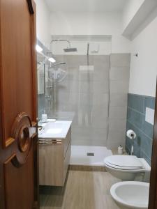 a bathroom with a shower and a toilet and a sink at D&P Suites 1 Salemi in Salemi