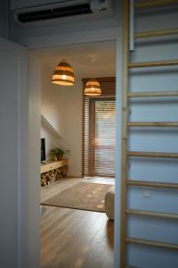 a hallway with a living room with a window at Pine Attic - new & cozy 3 bedroom apartment,Nida in Nida