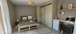 a small bedroom with a bed and a desk at Côté plage in Lacanau