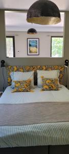 a bedroom with a large bed with colorful pillows at Côté plage in Lacanau