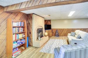 sala de estar con sofá y chimenea en Lake Michigan Home with Private Beach and Deck!, en Menominee